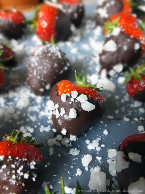 Strawberries coated in dark chocolate and sprinkled with rhubarb saffron sugar