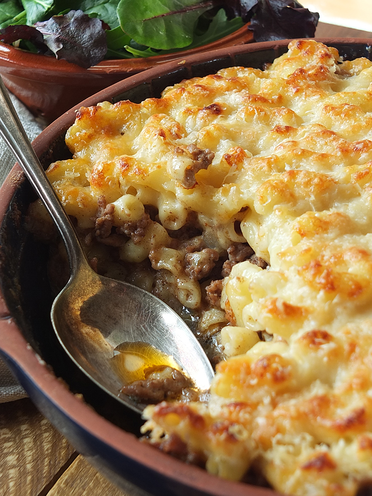 Close up image of Greek pastitsio showing the mouthwatering pasta, cheese and lamb mince filling.