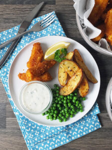 Homemade fish fingers with paprika-spiked potato wedges and homemade tartare sauce.