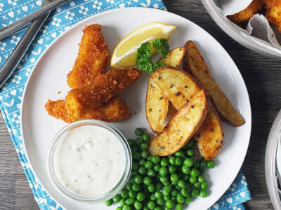 Homemade fish fingers with paprika-spiked potato wedges and homemade tartare sauce.