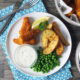 Homemade fish fingers with paprika-spiked potato wedges and homemade tartare sauce.