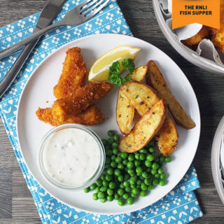 Homemade fish fingers with paprika-spiked potato wedges and homemade tartare sauce.