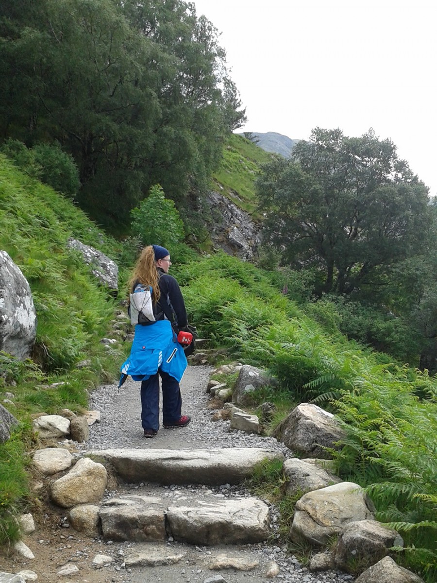 Steep steps on mountain path to the green alpine valley