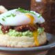Photo of homemade bacon jam on a toasted, buttered crumpet with smashed avocado topped with a perfectly poached runny egg.