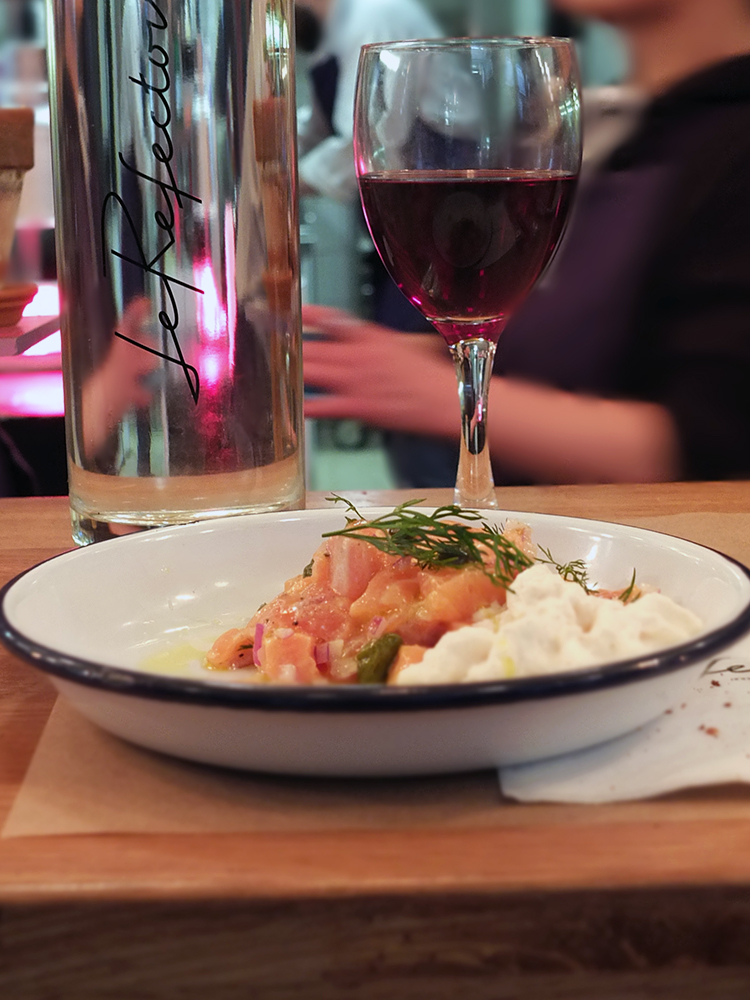 Image of Label Rouge Scottish salmon with hazelnut cream served on a tin camping platter. 