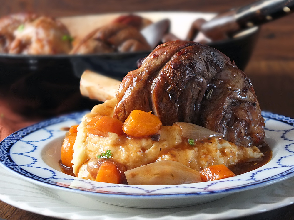 Slow Cooked Lamb Shanks with Vegetables and Gravy photograph.