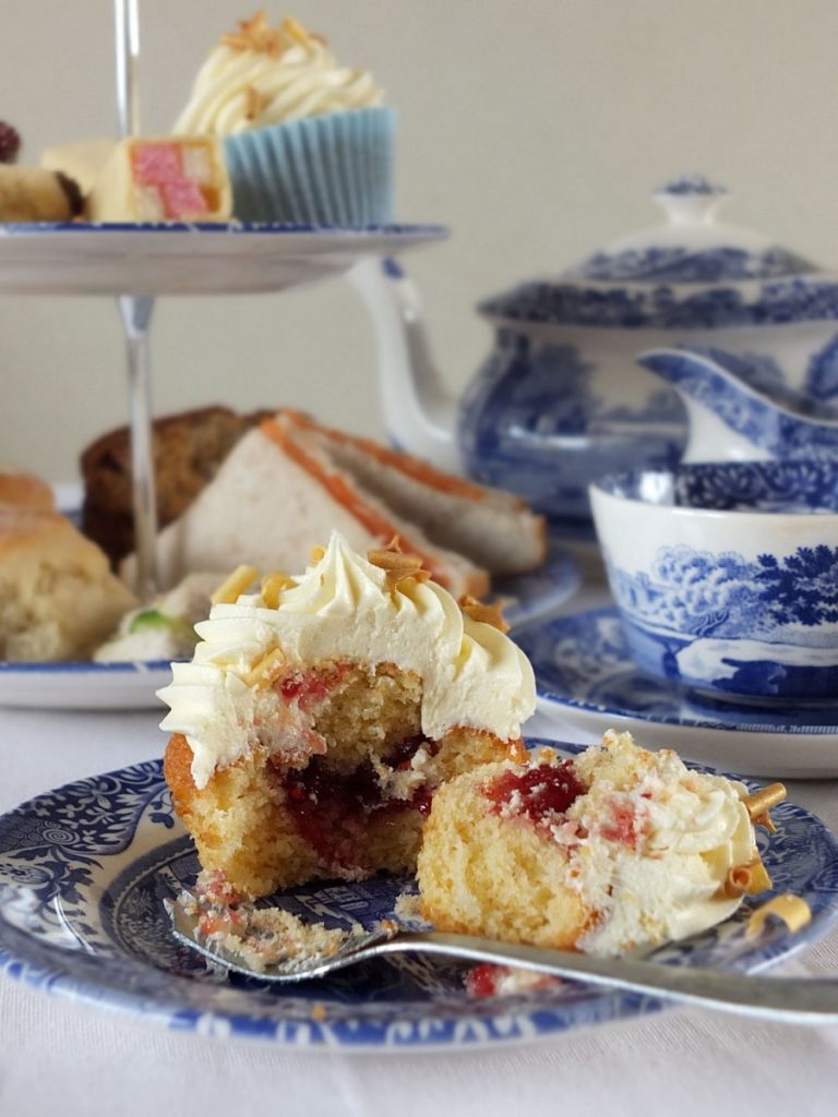 Raspberry Filled Vanilla Cupcakes with White Chocolate Frosting