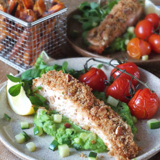 Baked nut-crusted salmon with pea puree & crispy sweet potato fries