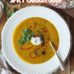 This delicious and warming spicy carrot soup contains seven different store-cupboard spices, as well as fresh ginger and garlic. It freezes and reheats well too, so you can batch cook it if you've got a glut of carrots. #carrotsoup #soup #elizabethskitchendiary