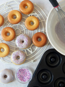 In this easy recipe, lemon zest, lemon extract and lavender flowers are combined to make a delicious, fluffy, moist, perfectly baked doughnut with a lavender icing sugar glaze. #doughnuts #bakeddoughnuts #lavender #lemondoughnut #lemondonut #bakeddonut