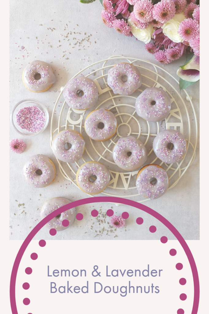 In this easy recipe, lemon zest, lemon extract and lavender flowers are combined to make a delicious, fluffy, moist, perfectly baked doughnut with a lavender icing sugar glaze. #doughnuts #bakeddoughnuts #lavender #lemondoughnut #lemondonut #bakeddonut