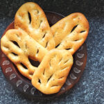 Fougasse bread is the French cousin of Italian focaccia, an oval white bread seasoned with olive oil and salt cut to resemble an ear of wheat.