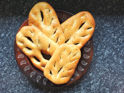 Fougasse bread is the French cousin of Italian focaccia, an oval white bread seasoned with olive oil and salt cut to resemble an ear of wheat.