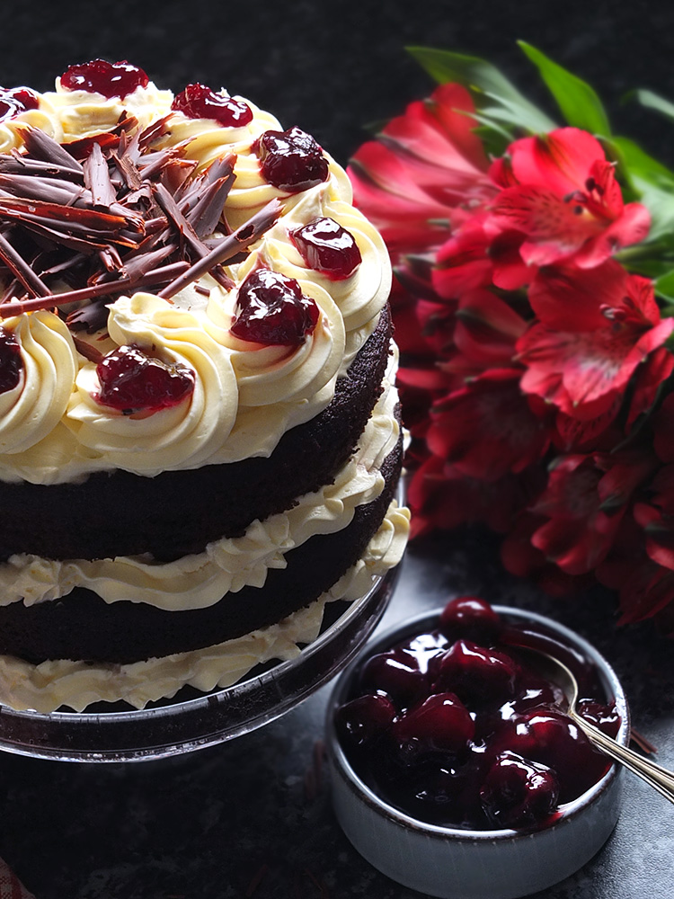 Layers of rich chocolate cake drizzled with cherry brandy sandwiched together with sweetened whipped cream and black cherry conserve. The cake is finished with more cream and some dark chocolate curls.