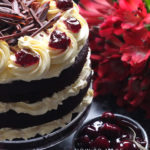 Three layers of rich chocolate cake drizzled with cherry brandy sandwiched together with sweetened whipped cream and black cherry conserve. The cake is finished with more cream and some dark chocolate curls. #chocolate #chocolatecake #blackforestcake #baking