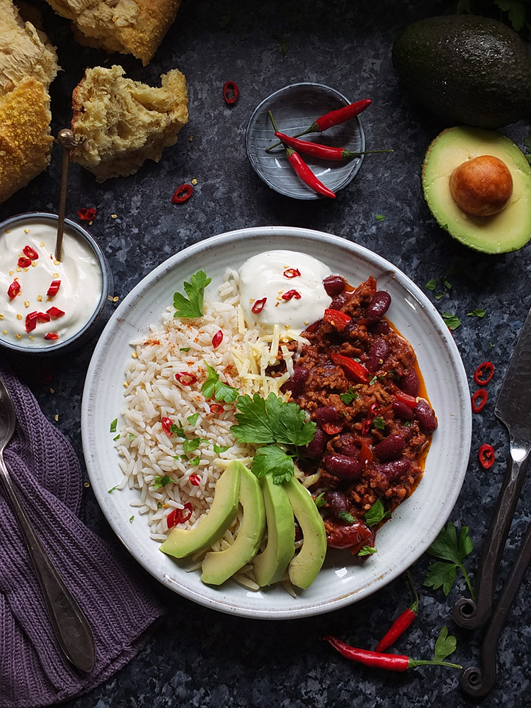This super easy Chilli con Carne recipe is made with lamb mince, which lends a delicious earthy flavour to the classic dish. Serve with rice, soured cream and slices of creamy avocado - perfect for a midweek meal.