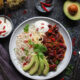 This super easy Chilli con Carne recipe is made with lamb mince, which lends a delicious earthy flavour to the classic dish. Serve with rice, soured cream and slices of creamy avocado - perfect for a midweek meal. #chilli #chilliconcarne #trylamb #lamb