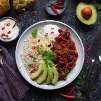 This super easy Chilli con Carne recipe is made with lamb mince, which lends a delicious earthy flavour to the classic dish. Serve with rice, soured cream and slices of creamy avocado - perfect for a midweek meal. #chilli #chilliconcarne #trylamb #lamb