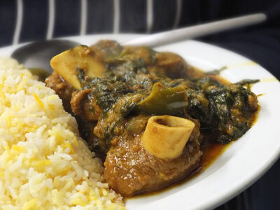 Slow cooked bone in lamb cooked with spices, spinach, onions and peppers.