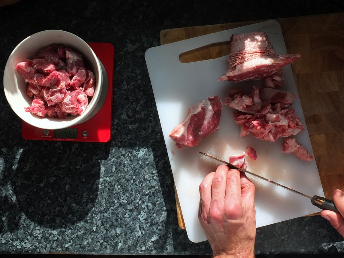 image of Cutting lamb shoulder into cubes for kebab skewers 