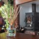 image of the limited edition room fragrance by Arla sitting on table with country fireplace in background