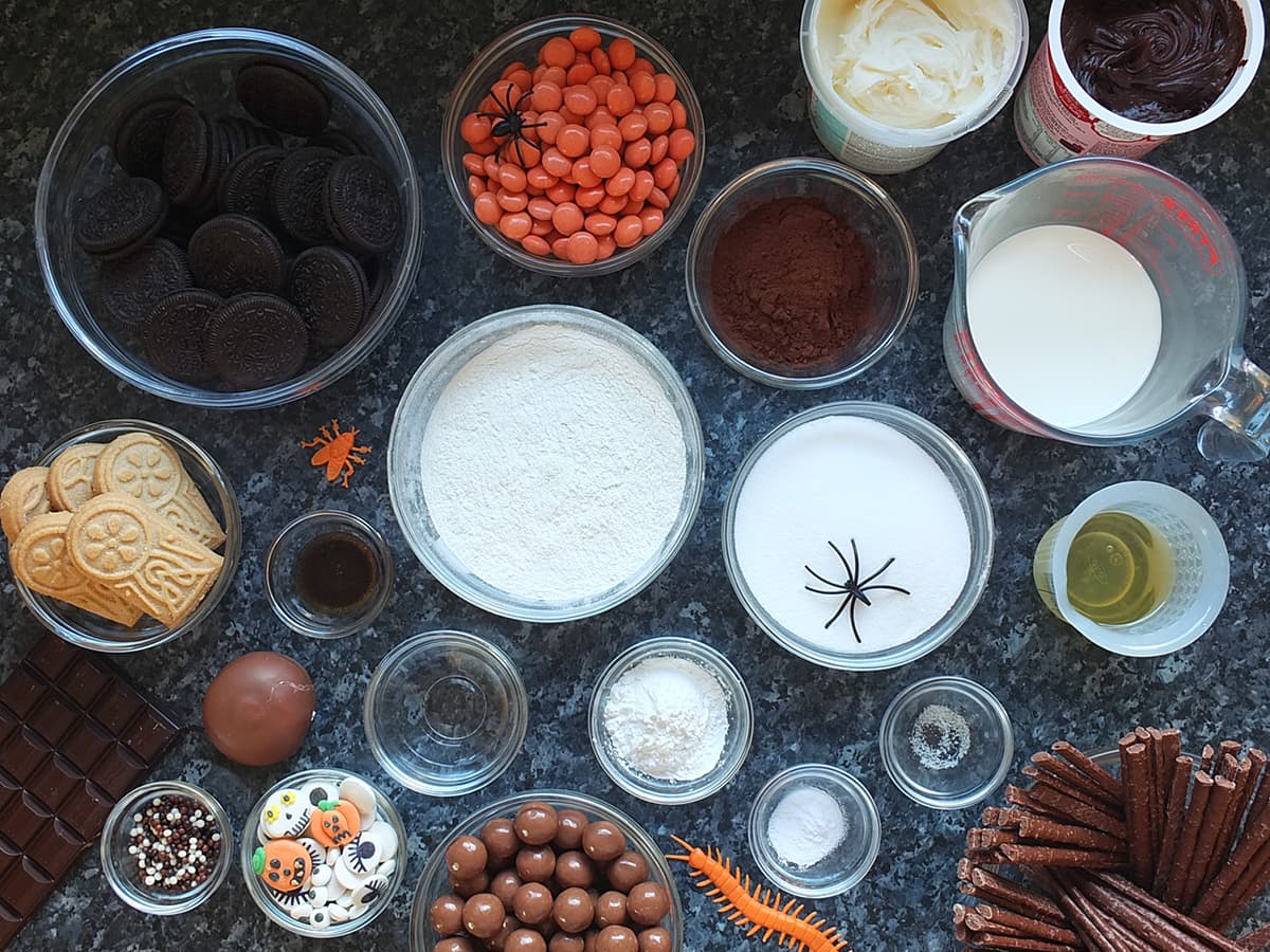 Top down image of all the ingredients needed to make an egg free chocolate Halloween graveyard cake.