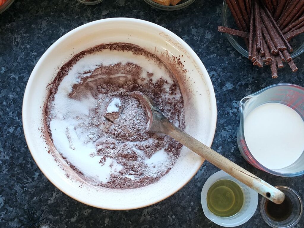 Image of step 2 - stirring in the caster sugar with a wooden spoon.