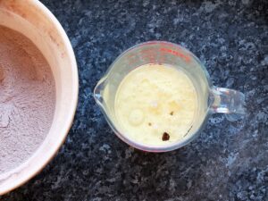 Image of step three - combining the wet ingredients in a glass measuring jug.