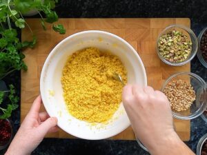 Photo of fluffing couscous with a fork.