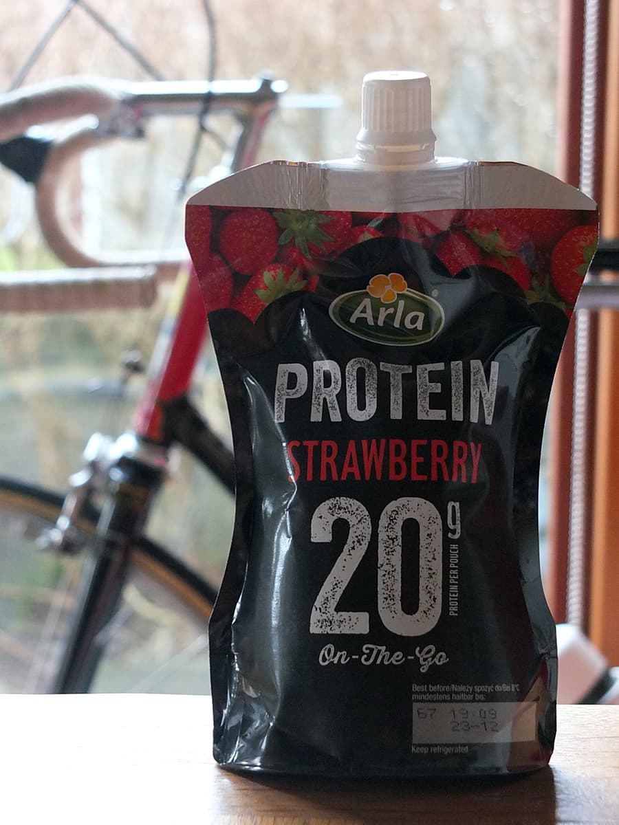 Image of Arla Protein 20 pouch with a vintage 1954 Jack Taylor bicycle in the background.