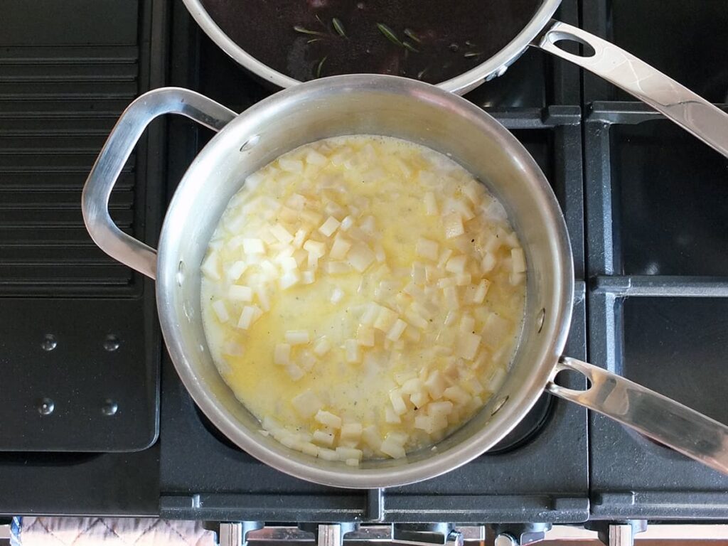 Top down photo of celeriac cooking in a pan.