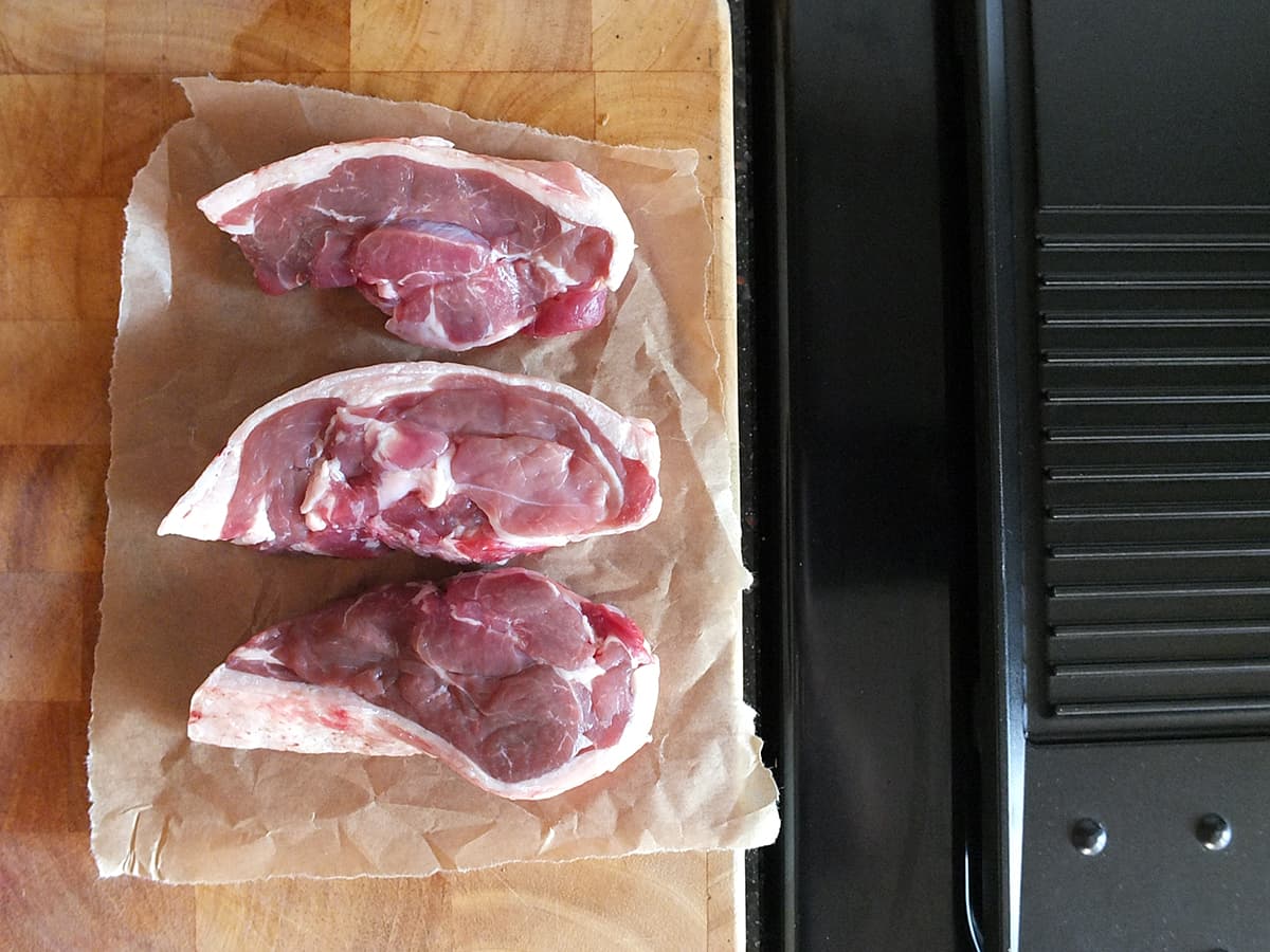 Image of three Shetland lamb leg steaks coming to room temperature before cooking.
