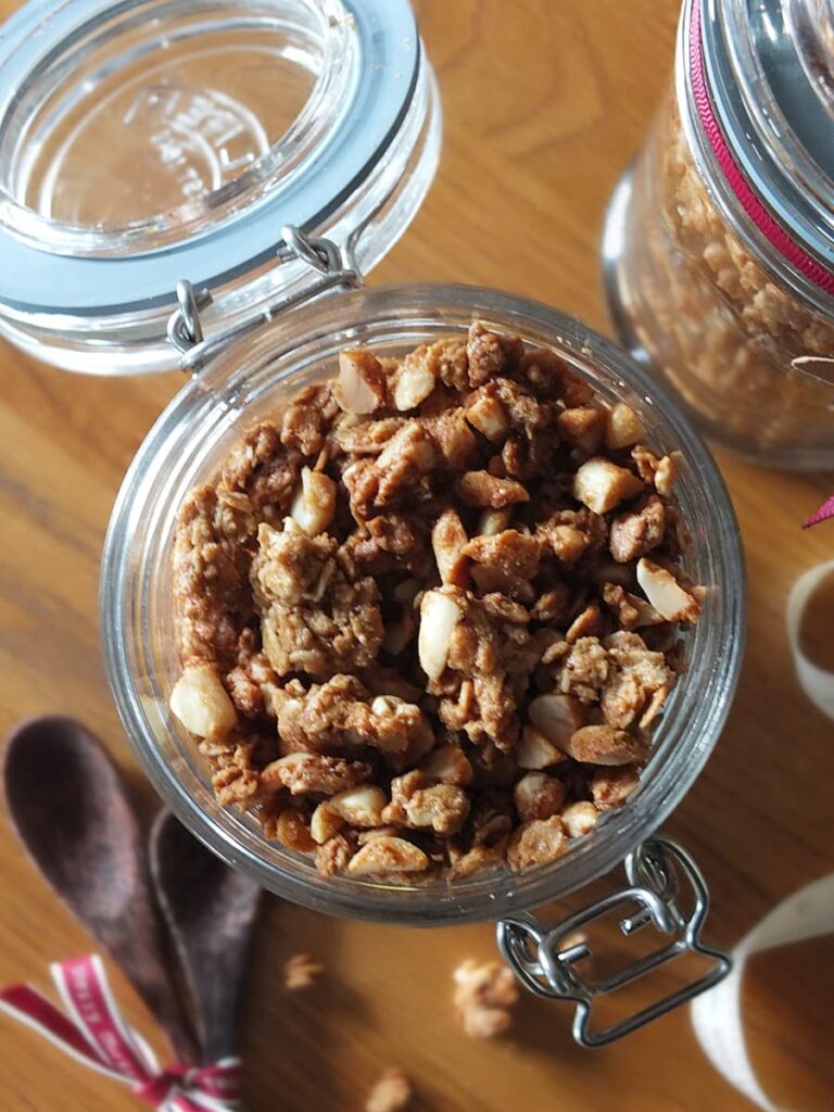 Top down close up of peanut butter granola in a glass jar.