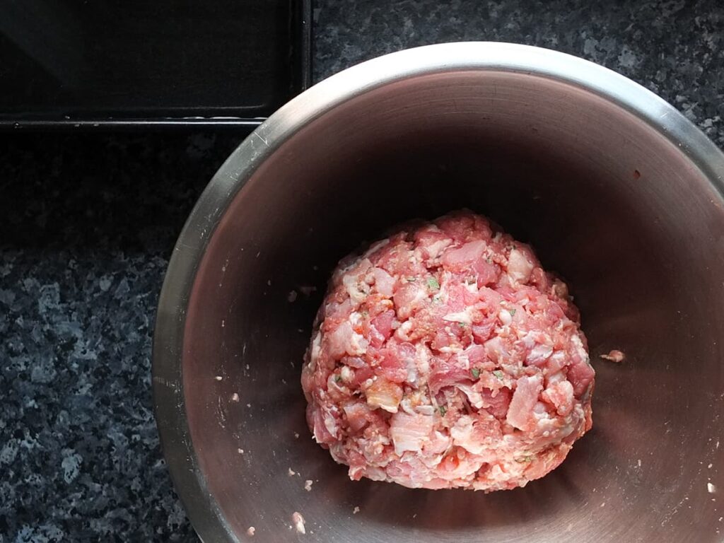 Top down photo of all the pork pie filling ingredients combined into one large ball.