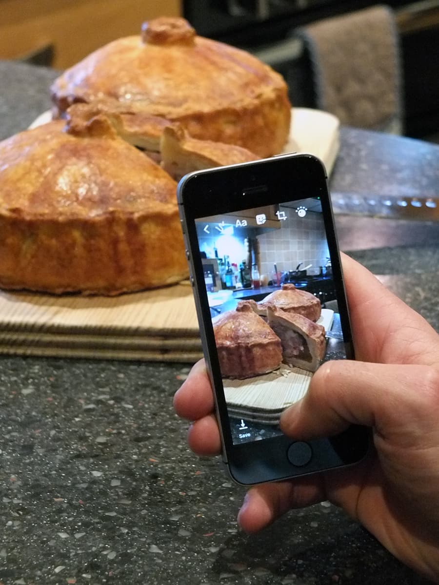 Photo of my boyfriend taking an iPhone picture of my pork pies to share on Instagram because he was that impressed by them.