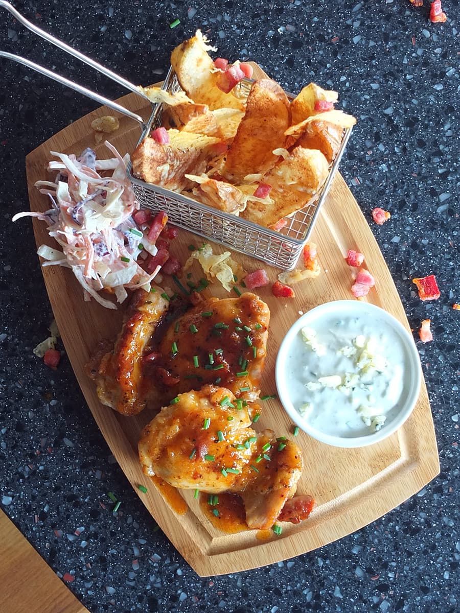 Top down image of Superbowl food on a wooden board.