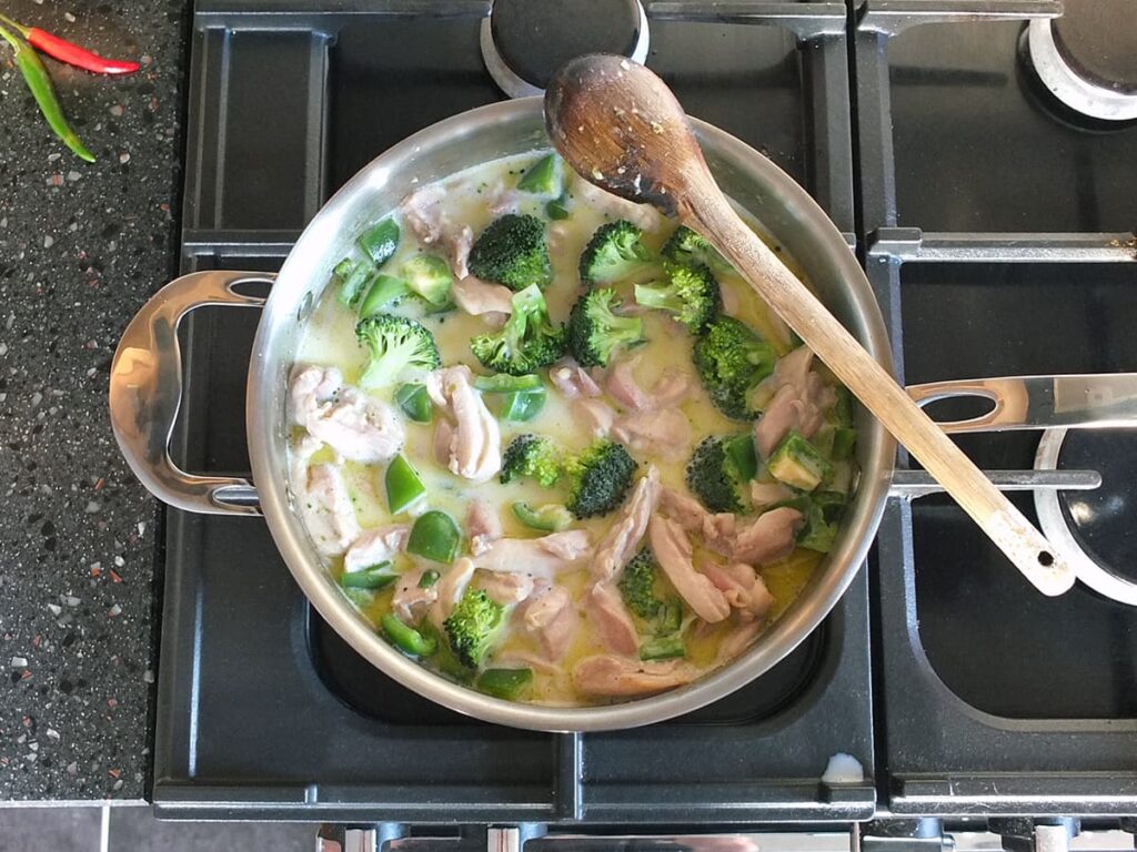 Top down image of Thai green curry after coconut milk has been added.