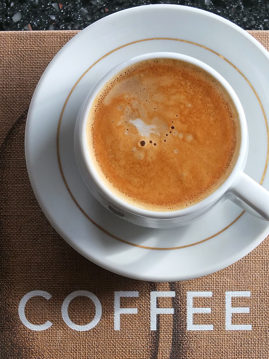 Top down image of a coffee cup showing the crema layer of a good cup of coffee. 