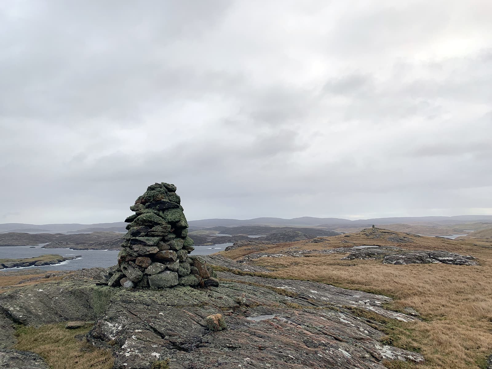 Image with two cairns on hilltops in Shetland.