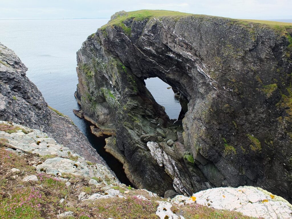 Image of a dramatic natural sea arch in Fetlar, Shetland.
