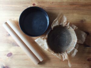 Image of two cake tins, one lined with non stick baking paper.