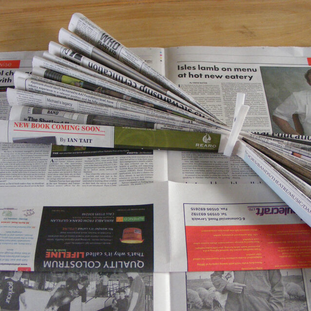 Image of newspaper folded in an accordion shape to make strips one inch thick.