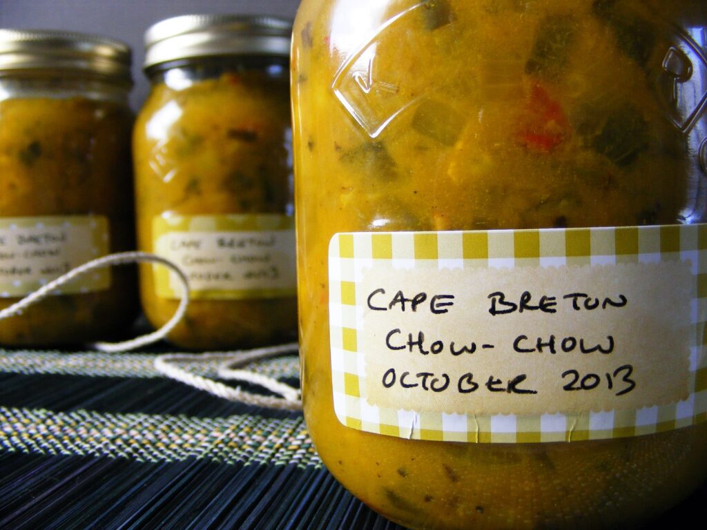 Image of preserve bottles filled with green tomato relish, also known as chow chow.