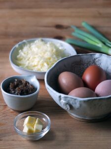 Photo of the ingredients used in a bacon jam omelette with cheddar.