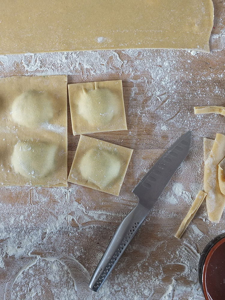 Rolling out homemade pasta dough with a pasta machine