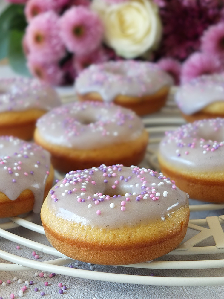 In this easy baked doughnuts recipe, lemon zest, lemon extract and lavender flowers are combined to make a delicious, fluffy, moist, perfectly baked doughnut with a lavender icing sugar glaze. #doughnuts #bakeddoughnuts #lavender #lemondoughnut #lemondonut #bakeddonut